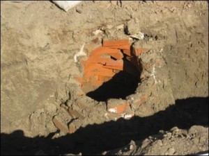 a hole in the ground lined with bricks